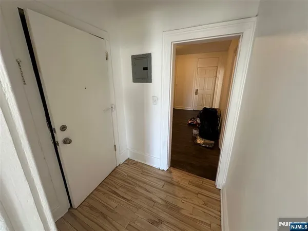 a view of hallway with wooden floor