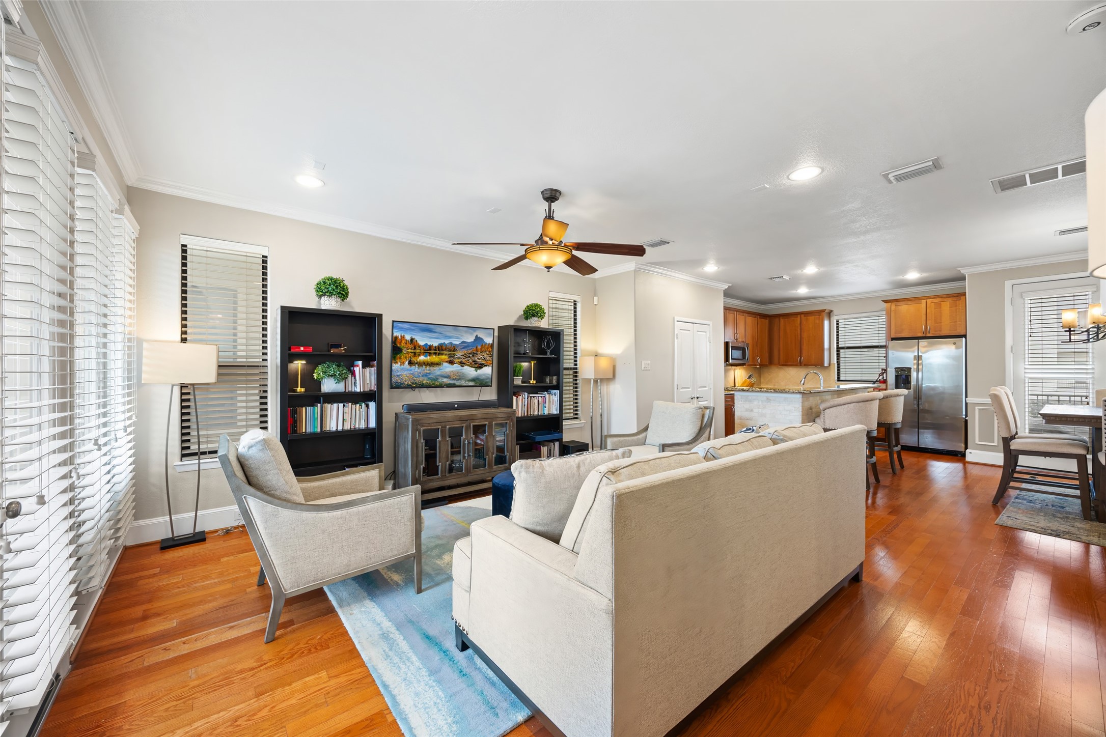 2320 Emancipation Avenue Houston, TX 77004 - Photo 16 of 38 a living room with furniture kitchen view and a wooden floor