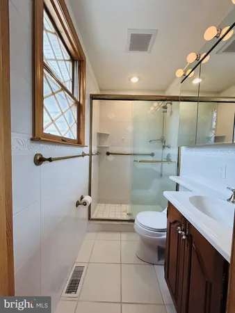 a bathroom with a sink toilet and a mirror