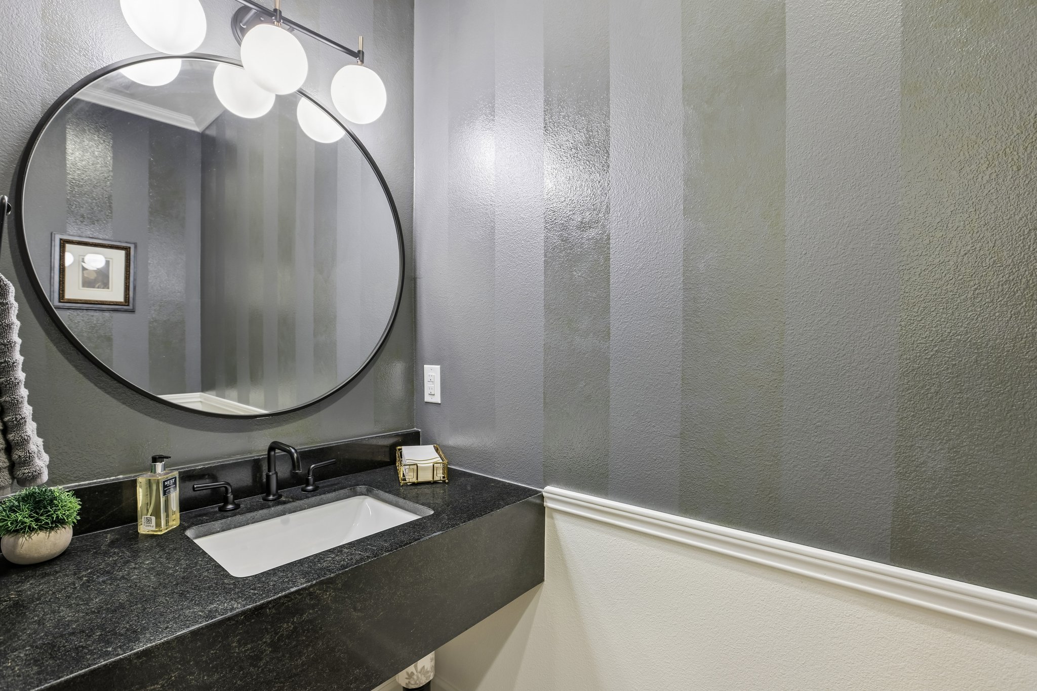 113 Crystal Lane Georgetown, TX 78633 - Photo 17 of 32 A well-appointed powder room features a sleek vanity and a contemporary round mirror.