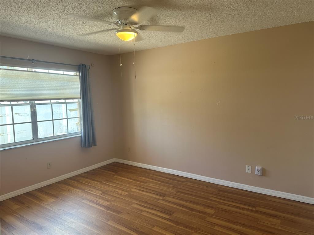 2250 Druid Road, Unit 403 Clearwater, FL 33764 - Photo 11 of 17 wooden floor in an empty room with a window