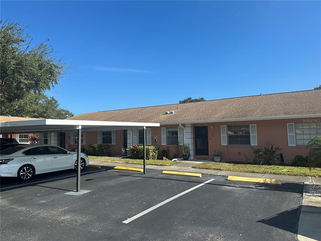 2250 Druid Road, Unit 403 Clearwater, FL 33764 - Photo 2 of 17 a view of a cars park in front of house