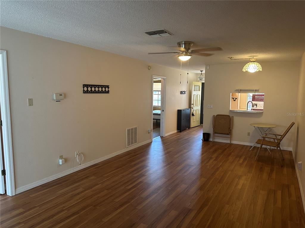 2250 Druid Road, Unit 403 Clearwater, FL 33764 - Photo 10 of 17 a view of a livingroom with furniture wooden floor and a ceiling fan