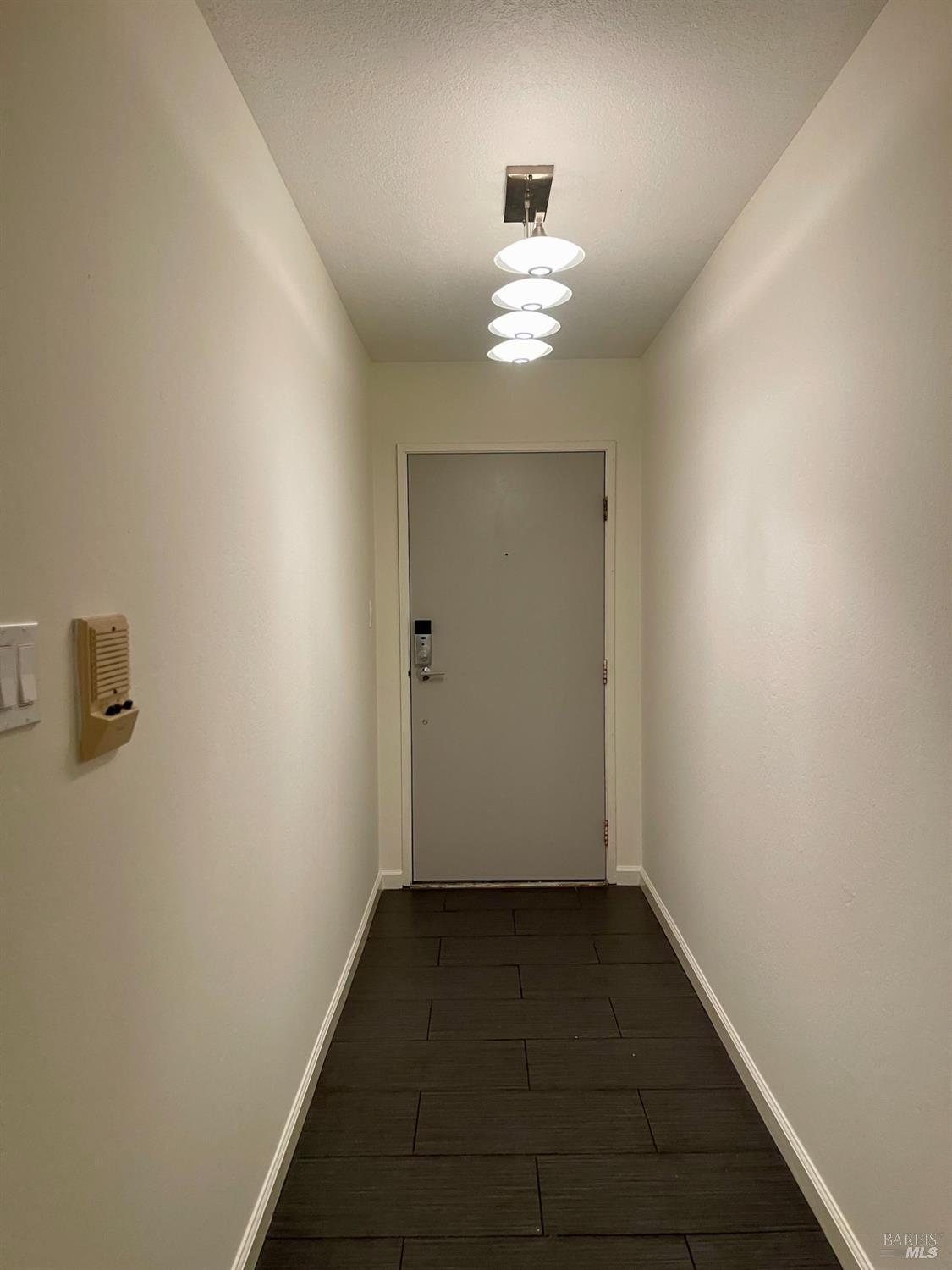 1 Embarcadero West, Unit 355 Oakland, CA 94607 - Photo 16 of 20 a view of a hallway with wooden floor