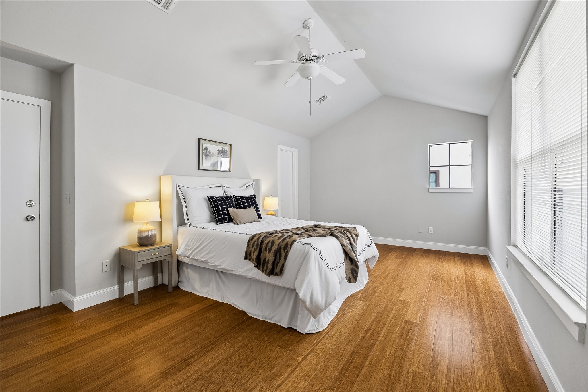 939 Colorado Street, Unit 22 Houston, TX 77007 - Photo 11 of 23 a bedroom with a bed and wooden floor