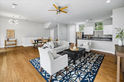 a living room with furniture and wooden floor