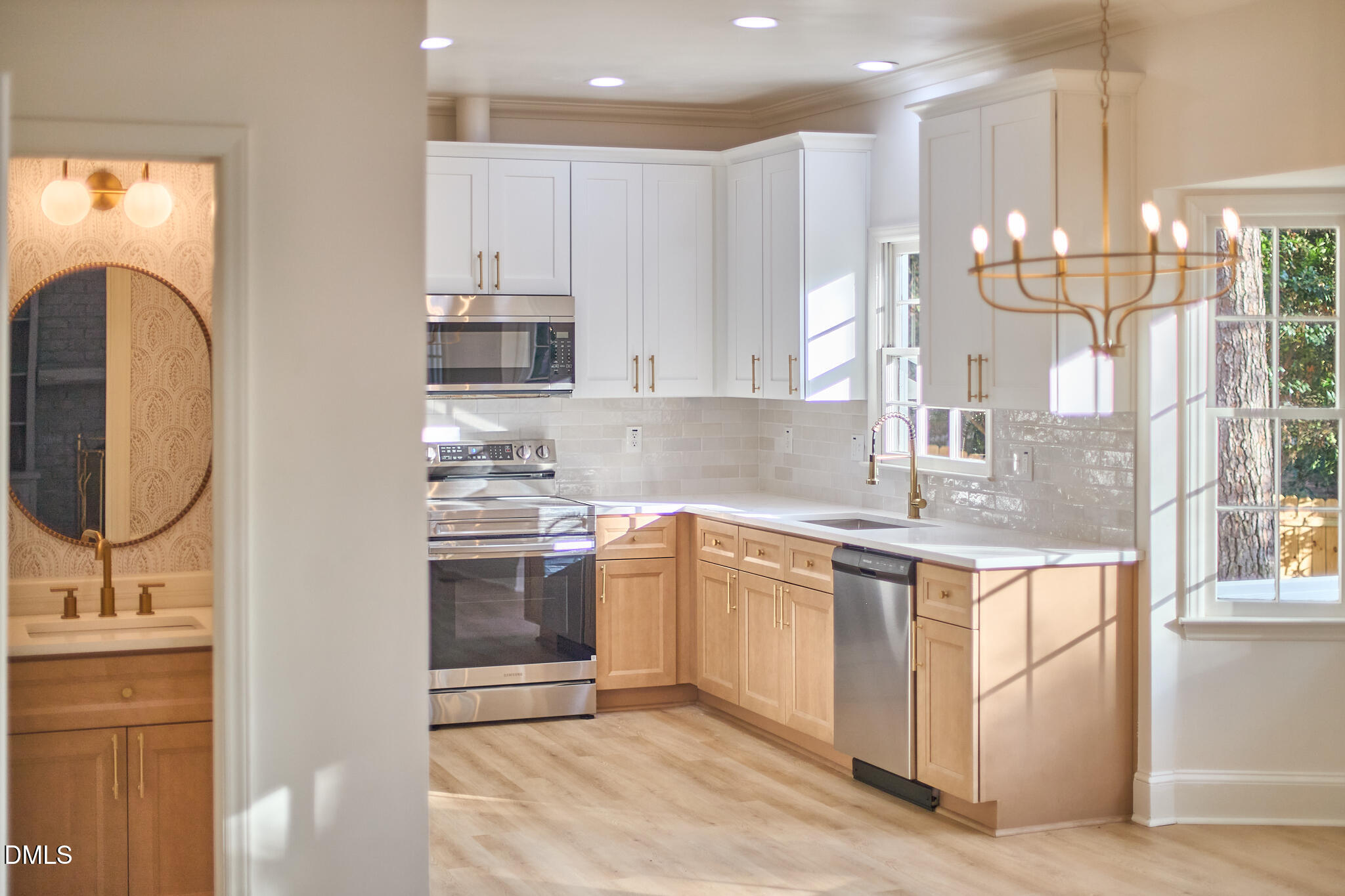 a kitchen with kitchen island granite countertop a sink stainless steel appliances and cabinets