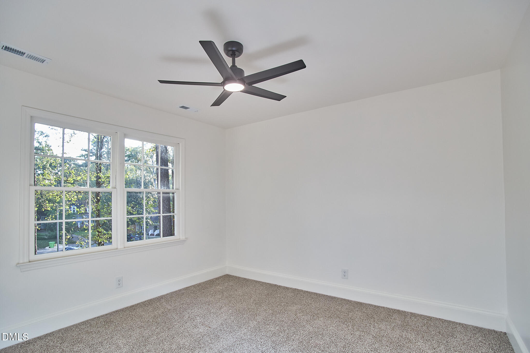 5721 Timber Ridge Drive Raleigh, NC 27609 - Photo 14 of 76 a view of a big room with wooden floor a ceiling fan and windows