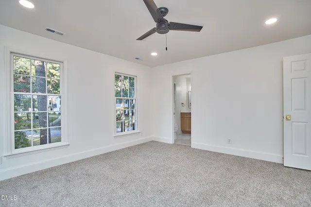 a view of a livingroom with a ceiling fan and window