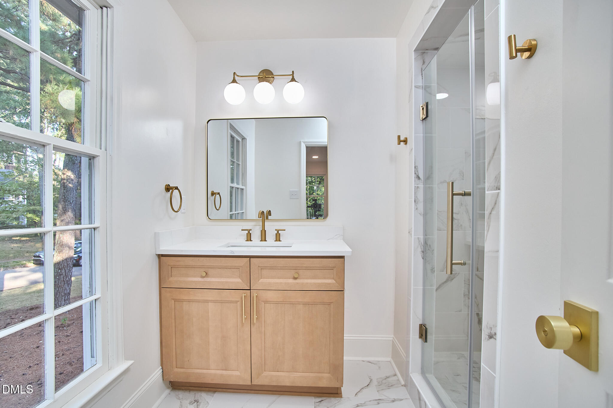 5721 Timber Ridge Drive Raleigh, NC 27609 - Photo 17 of 76 a bathroom with a sink and a mirror