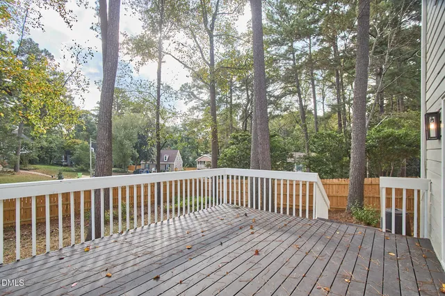 a view of a house with a tree and a yard