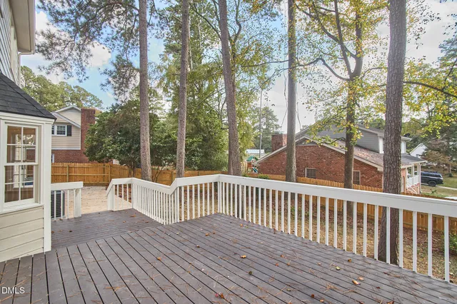a view of a house with a yard and sitting area