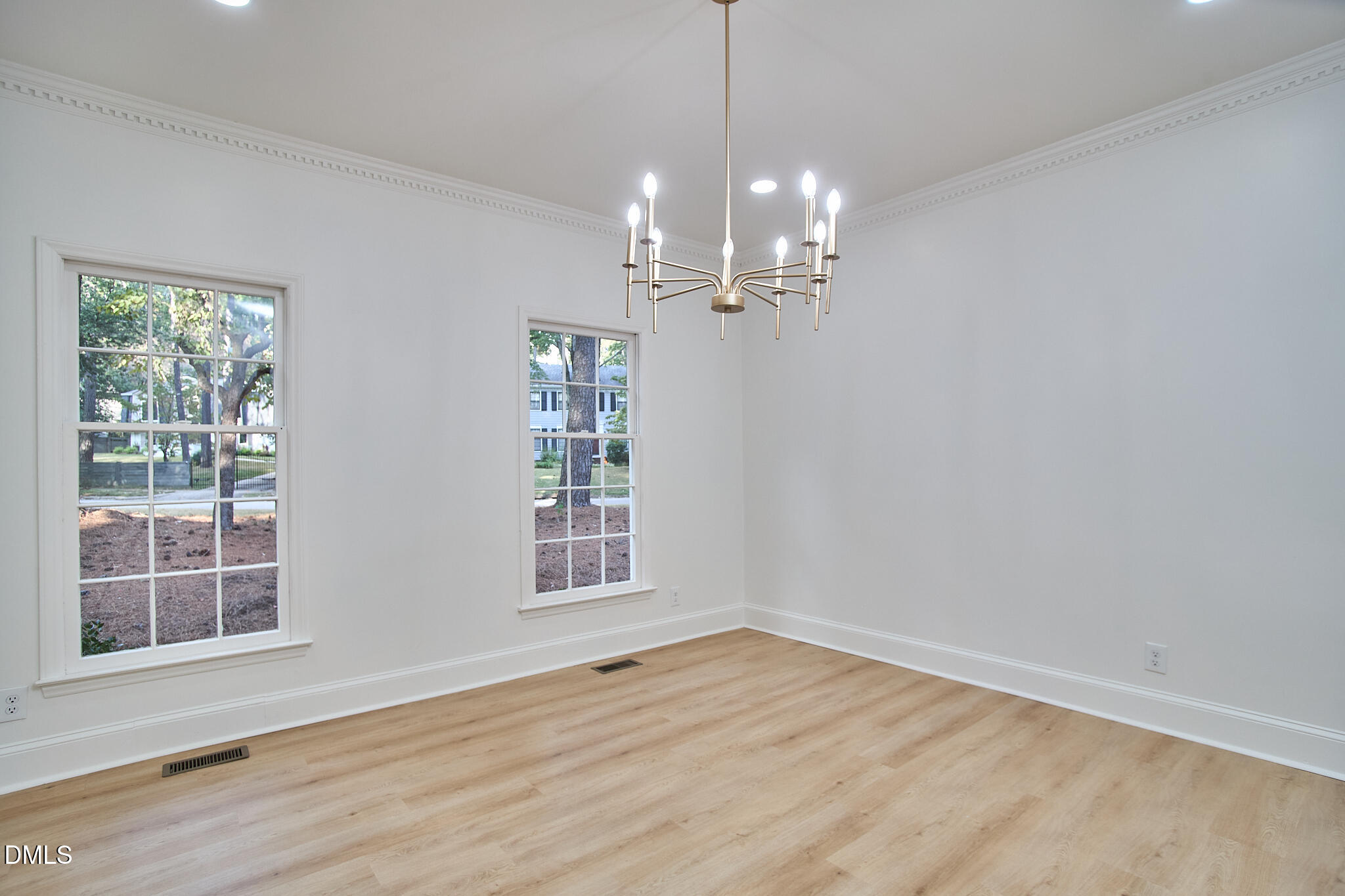 5721 Timber Ridge Drive Raleigh, NC 27609 - Photo 55 of 76 a view of empty room with wooden floor and fan