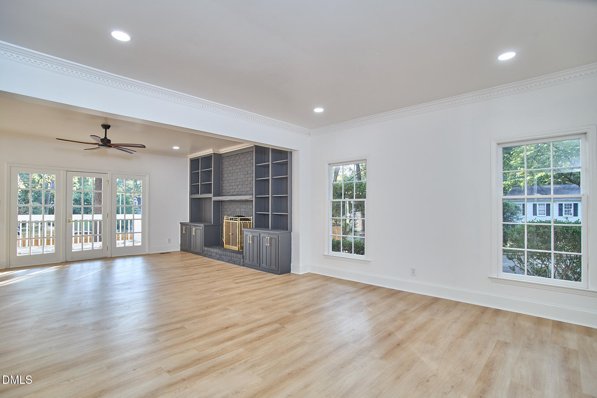 5721 Timber Ridge Drive Raleigh, NC 27609 - Photo 56 of 76 a view of an empty room with wooden floor and a window
