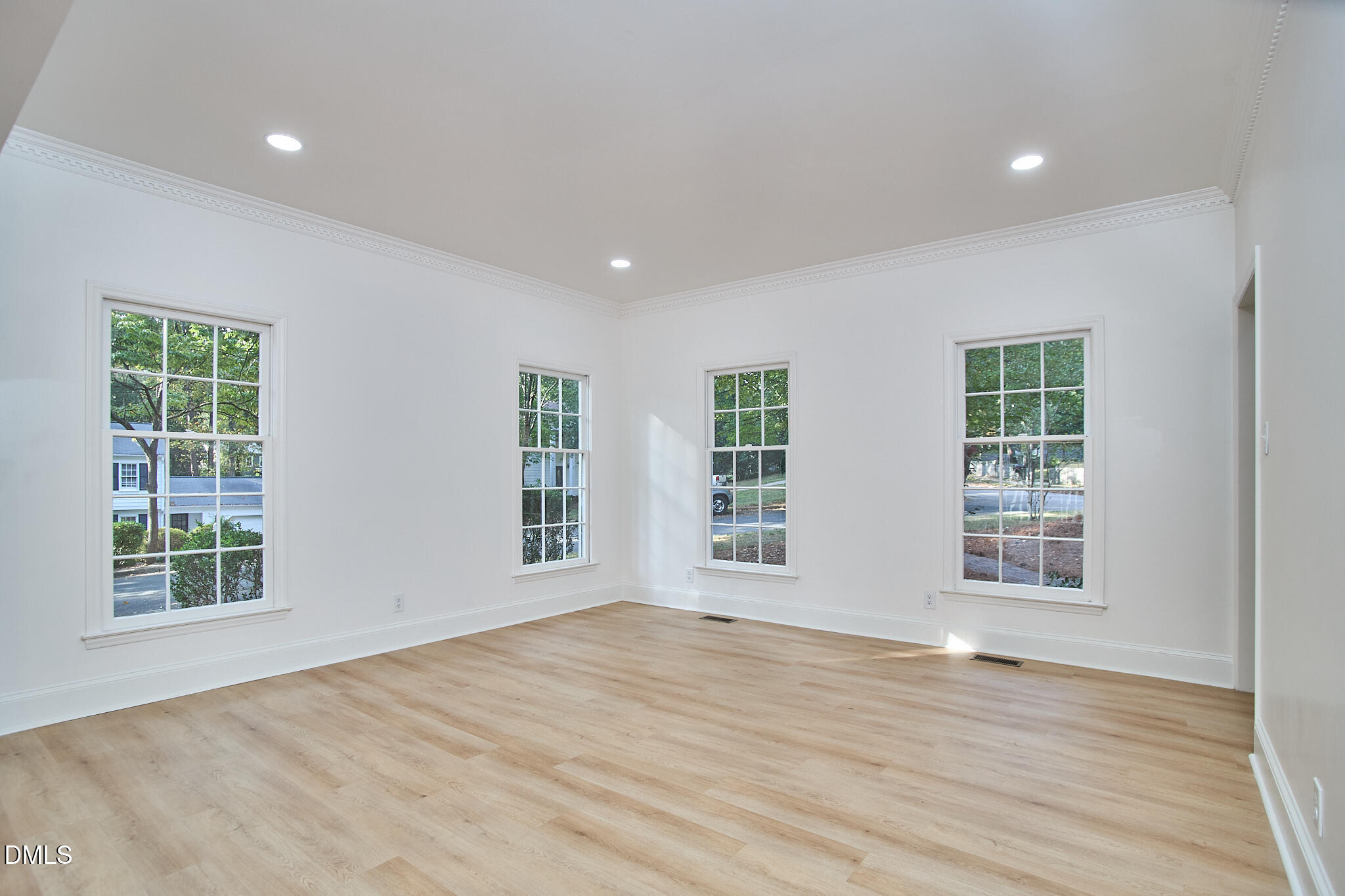 5721 Timber Ridge Drive Raleigh, NC 27609 - Photo 57 of 76 a view of an empty room with wooden floor and a window