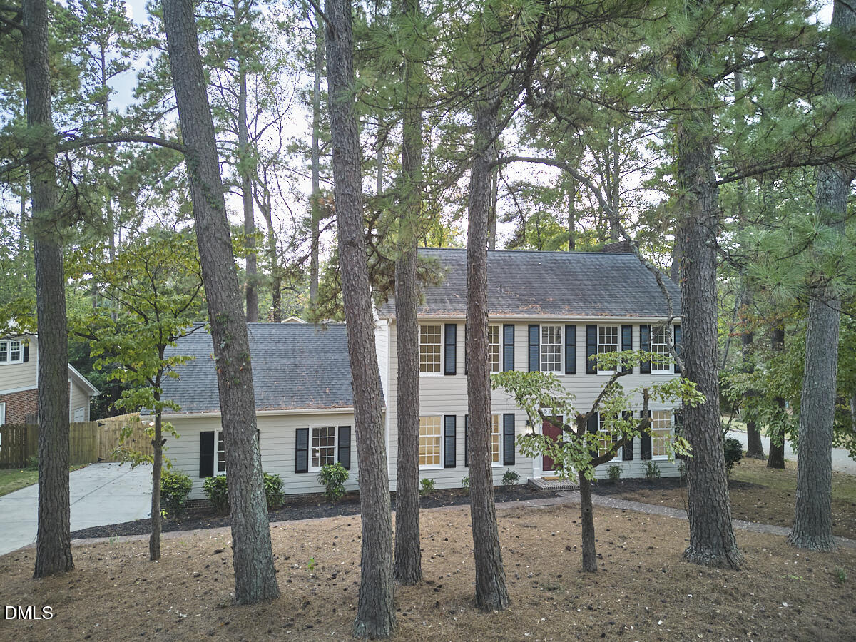 5721 Timber Ridge Drive Raleigh, NC 27609 - Photo 62 of 76 a view of a house with a tree and a yard