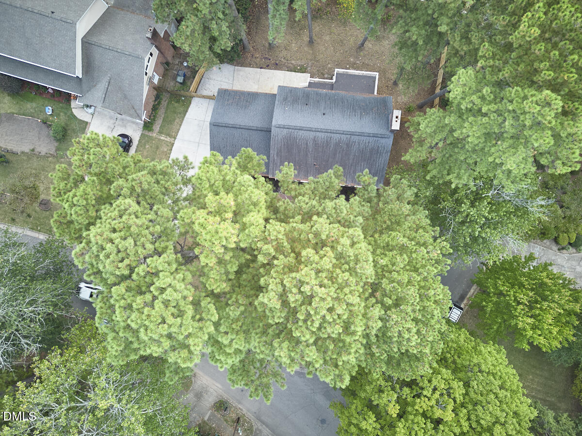 5721 Timber Ridge Drive Raleigh, NC 27609 - Photo 65 of 76 an aerial view of a house with a yard and large trees