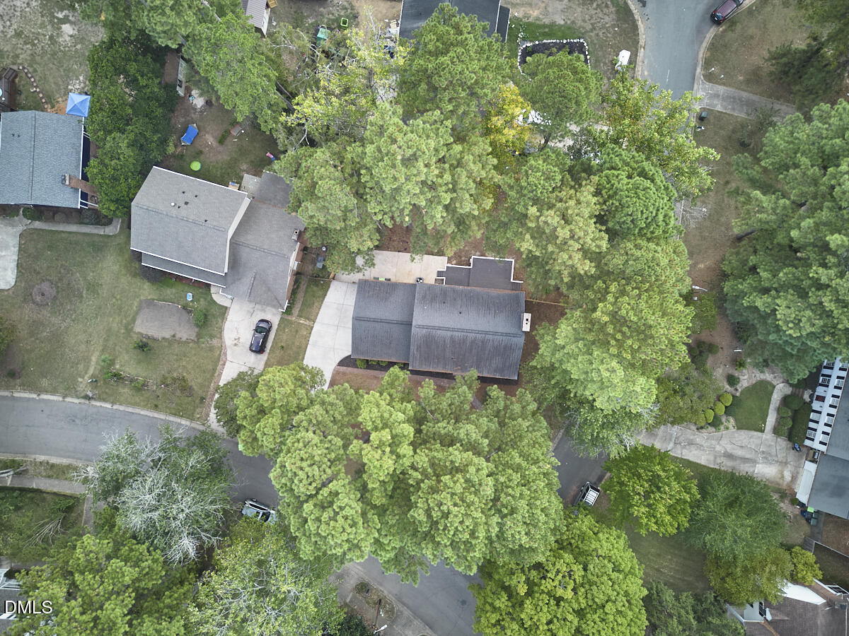 5721 Timber Ridge Drive Raleigh, NC 27609 - Photo 67 of 76 an aerial view of a house with a yard and trees all around