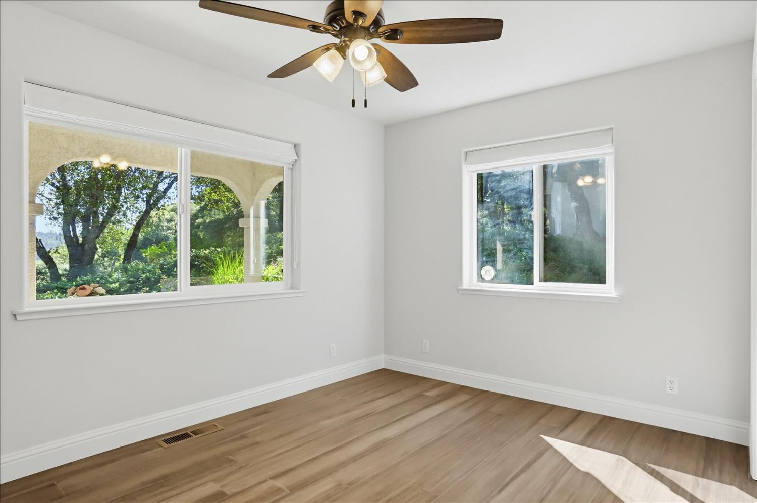 18639 Fay Ridge Court Grass Valley, CA 95949 - Photo 37 of 99 an empty room with wooden floor fan and windows