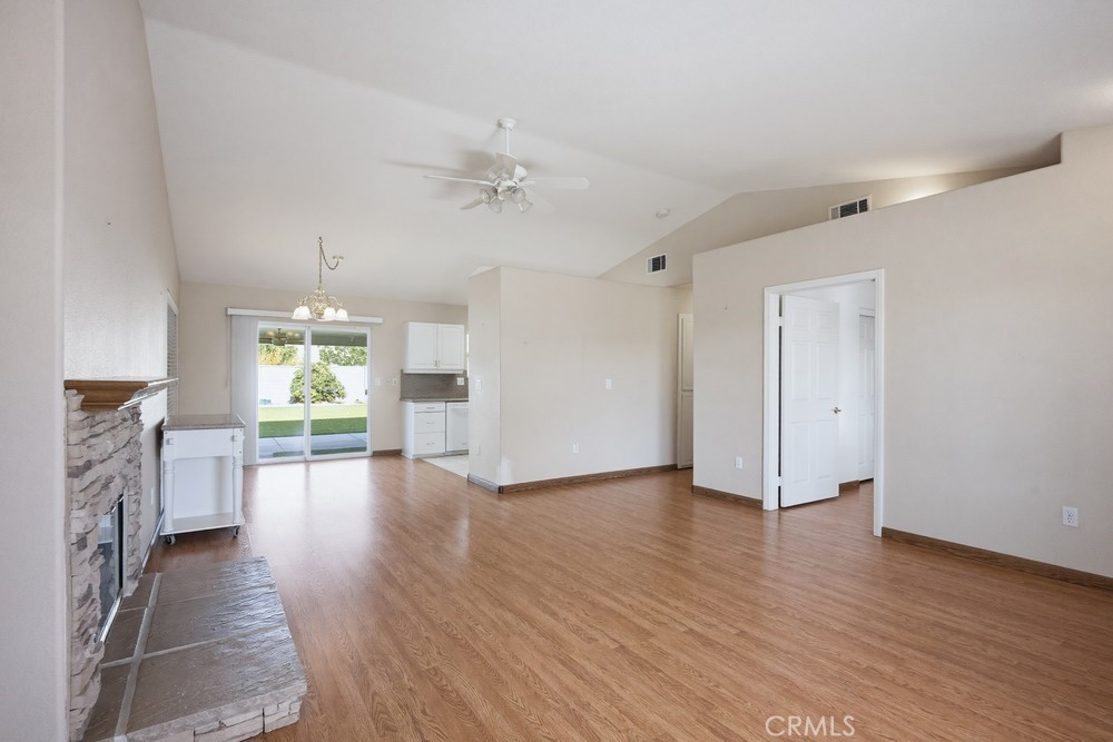 2998 Elder Way Hemet, CA 92545 - Photo 7 of 28 a view of a livingroom with furniture a fireplace and wooden floor
