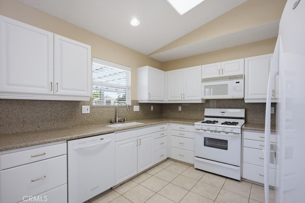 2998 Elder Way Hemet, CA 92545 - Photo 10 of 28 a kitchen with white cabinets stainless steel appliances and sink