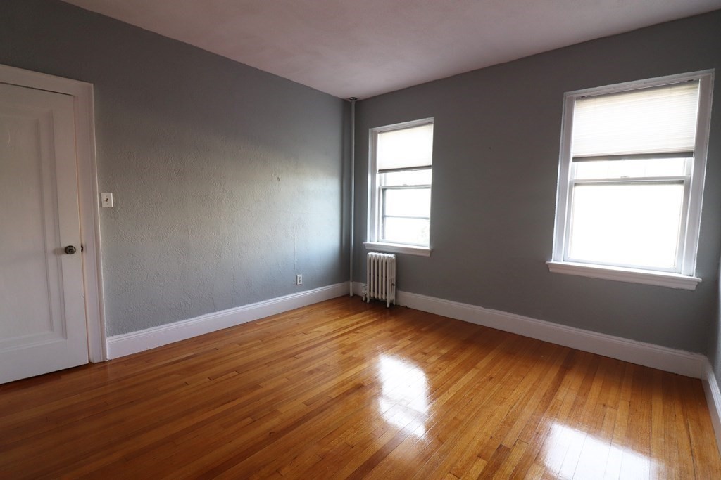 8 Chiswick Road, Unit 36 Boston, MA 02135 - Photo 11 of 16 a view of an empty room with wooden floor and a window