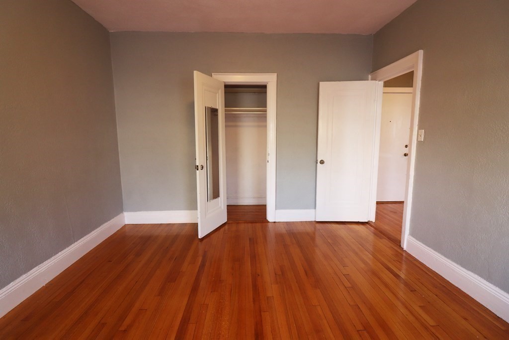 8 Chiswick Road, Unit 36 Boston, MA 02135 - Photo 12 of 16 a view of an empty room with wooden floor and closet