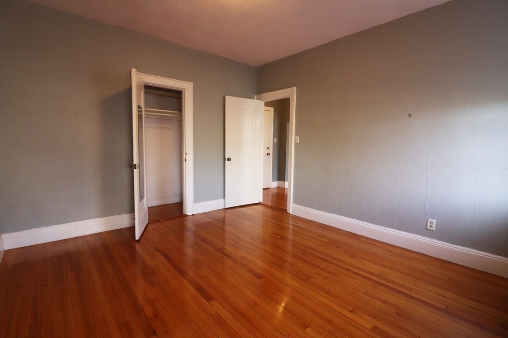 8 Chiswick Road, Unit 36 Boston, MA 02135 - Photo 13 of 16 a view of an empty room with wooden floor and closet