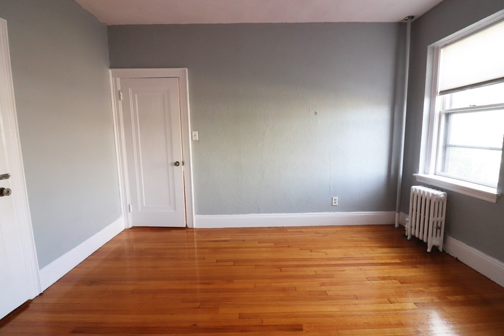 8 Chiswick Road, Unit 36 Boston, MA 02135 - Photo 14 of 16 an empty room with wooden floor and windows