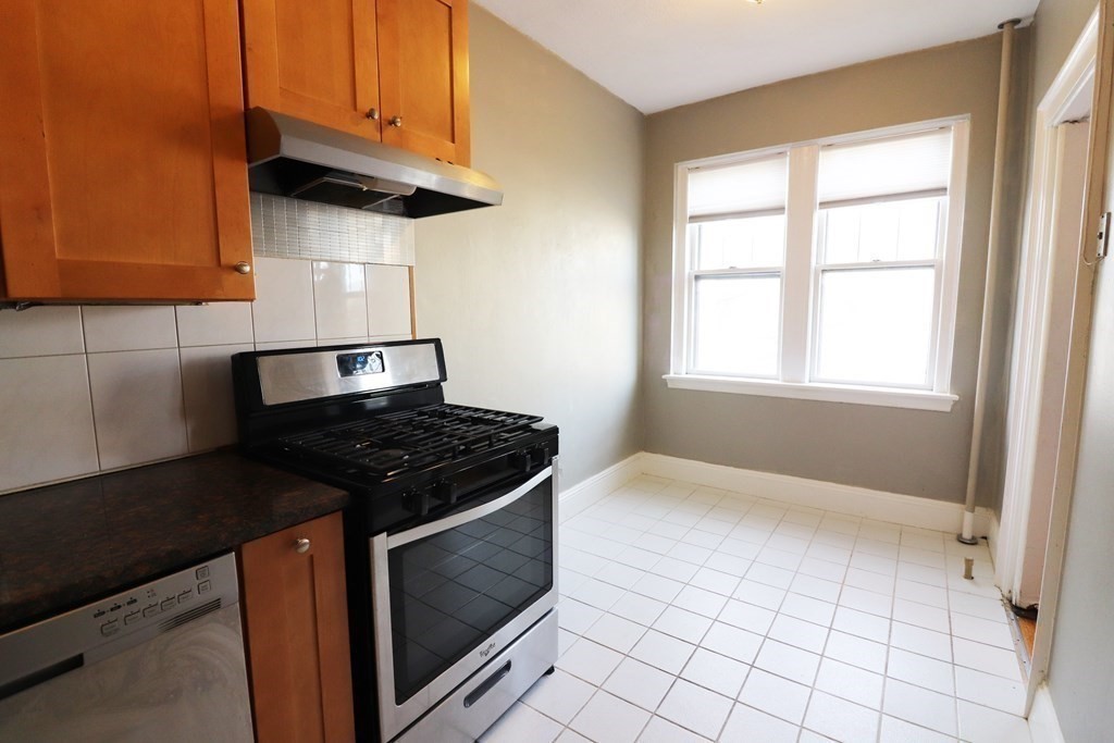 8 Chiswick Road, Unit 36 Boston, MA 02135 - Photo 2 of 16 a kitchen with granite countertop a stove and a sink