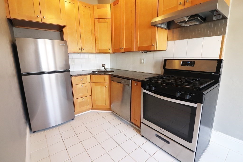 8 Chiswick Road, Unit 36 Boston, MA 02135 - Photo 3 of 16 a kitchen with a refrigerator sink and cabinets