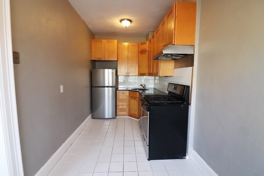 8 Chiswick Road, Unit 36 Boston, MA 02135 - Photo 4 of 16 a kitchen with a refrigerator and a stove