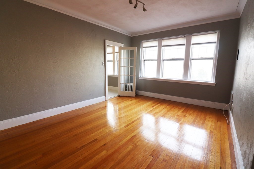 8 Chiswick Road, Unit 36 Boston, MA 02135 - Photo 5 of 16 wooden floor in an empty room with a window