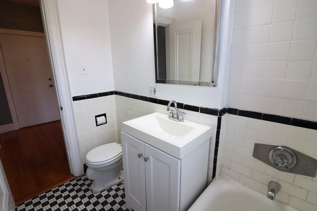 8 Chiswick Road, Unit 36 Boston, MA 02135 - Photo 10 of 16 a bathroom with a sink a toilet a mirror and vanity