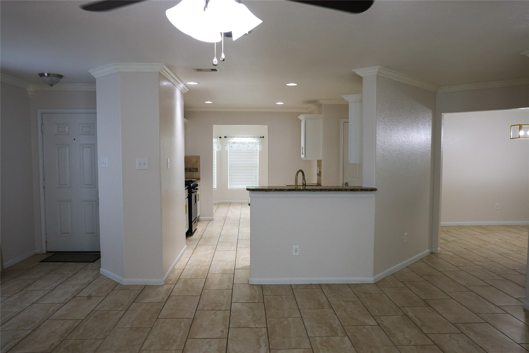 15631 South Fall Fern Circle Houston, TX 77044 - Photo 6 of 25 Kitchen featuring tile flooring, a breakfast bar, and recessed lighting.