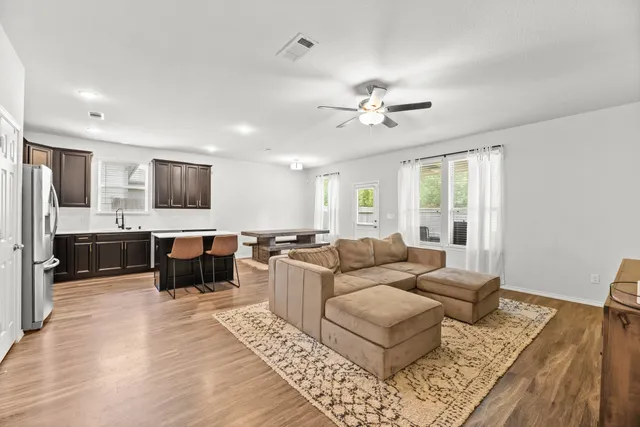 a living room with furniture and wooden floor