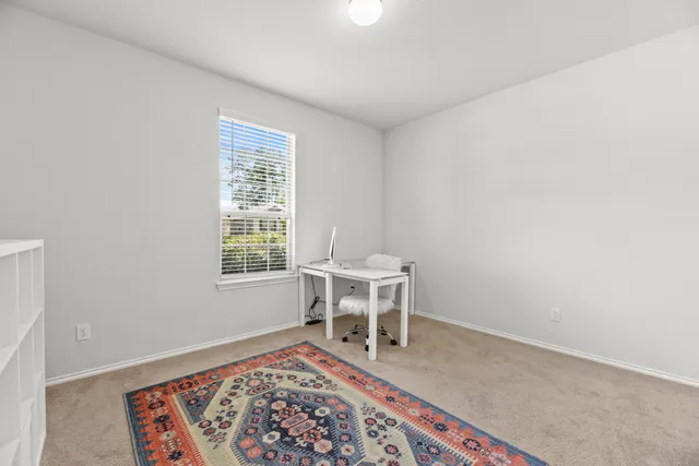 a living room with a rug and a table