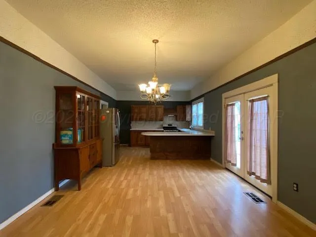 a view of kitchen with refrigerator microwave and wooden floor
