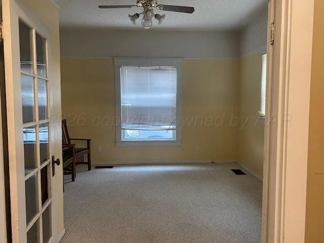 a view of room with a ceiling fan