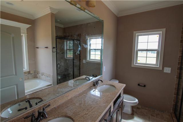 776 Academy Road, Unit 6C Lebanon, TN 37087 - Photo 10 of 16 a bathroom with a granite countertop sink a toilet and shower