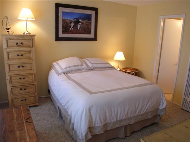 3566 Modoc Road, Unit 36 Santa Barbara, CA 93105 - Photo 14 of 18 a bedroom with a bed and a lamp on the dresser