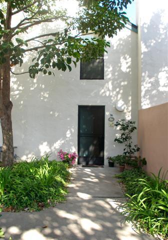 3566 Modoc Road, Unit 36 Santa Barbara, CA 93105 - Photo 4 of 18 a front view of a house with a yard and a garage