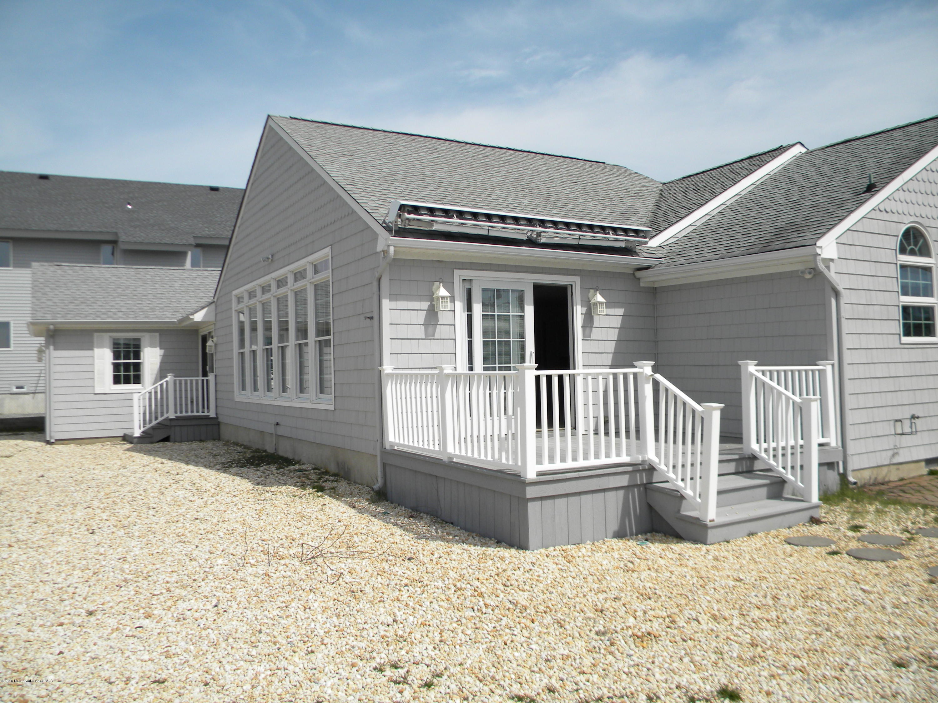 249 Silver Beach Road Lavallette, NJ 08735 - Photo 14 of 49 a view of a house with wooden fence