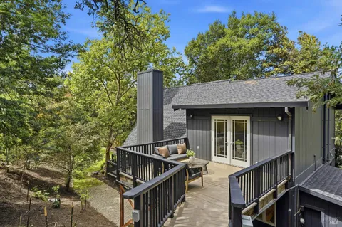 a view of house with roof deck and furniture