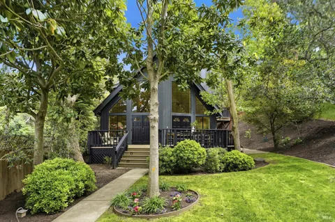 a front view of a house with a yard garage and outdoor seating