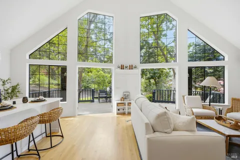 a living room with furniture and large windows