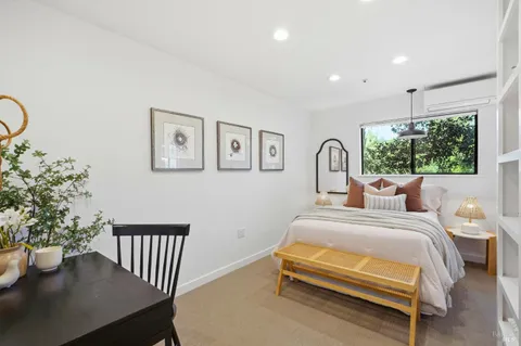 a bedroom with a bed and a potted plant