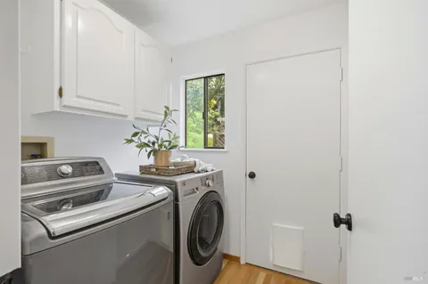 a view of a storage and utility room with washer and dryer