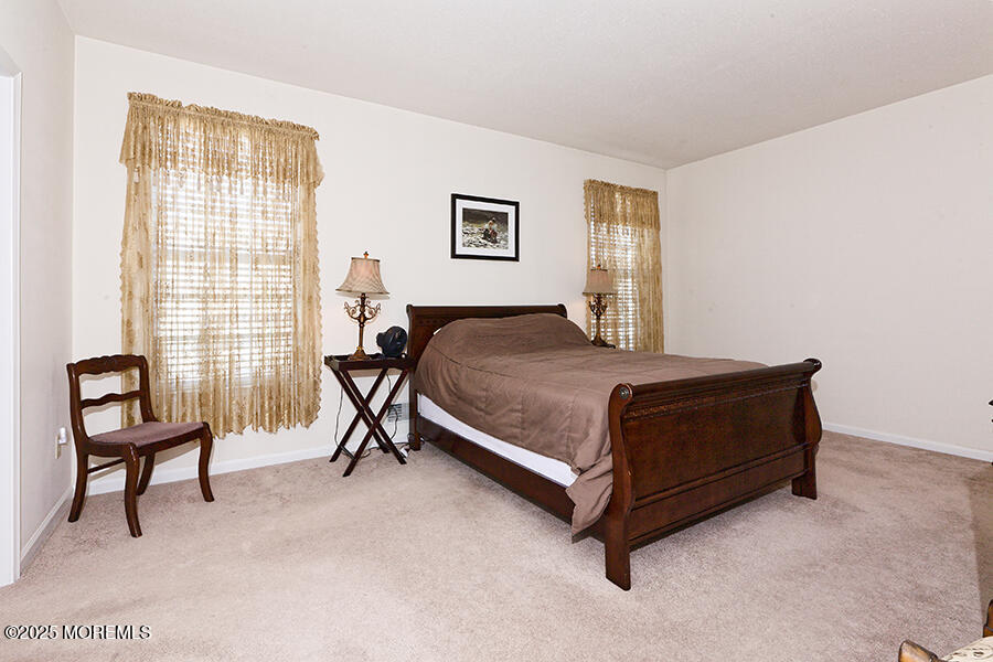 80 Robin Lane Barnegat, NJ 08005 - Photo 18 of 24 a bedroom with a bed chair and two windows