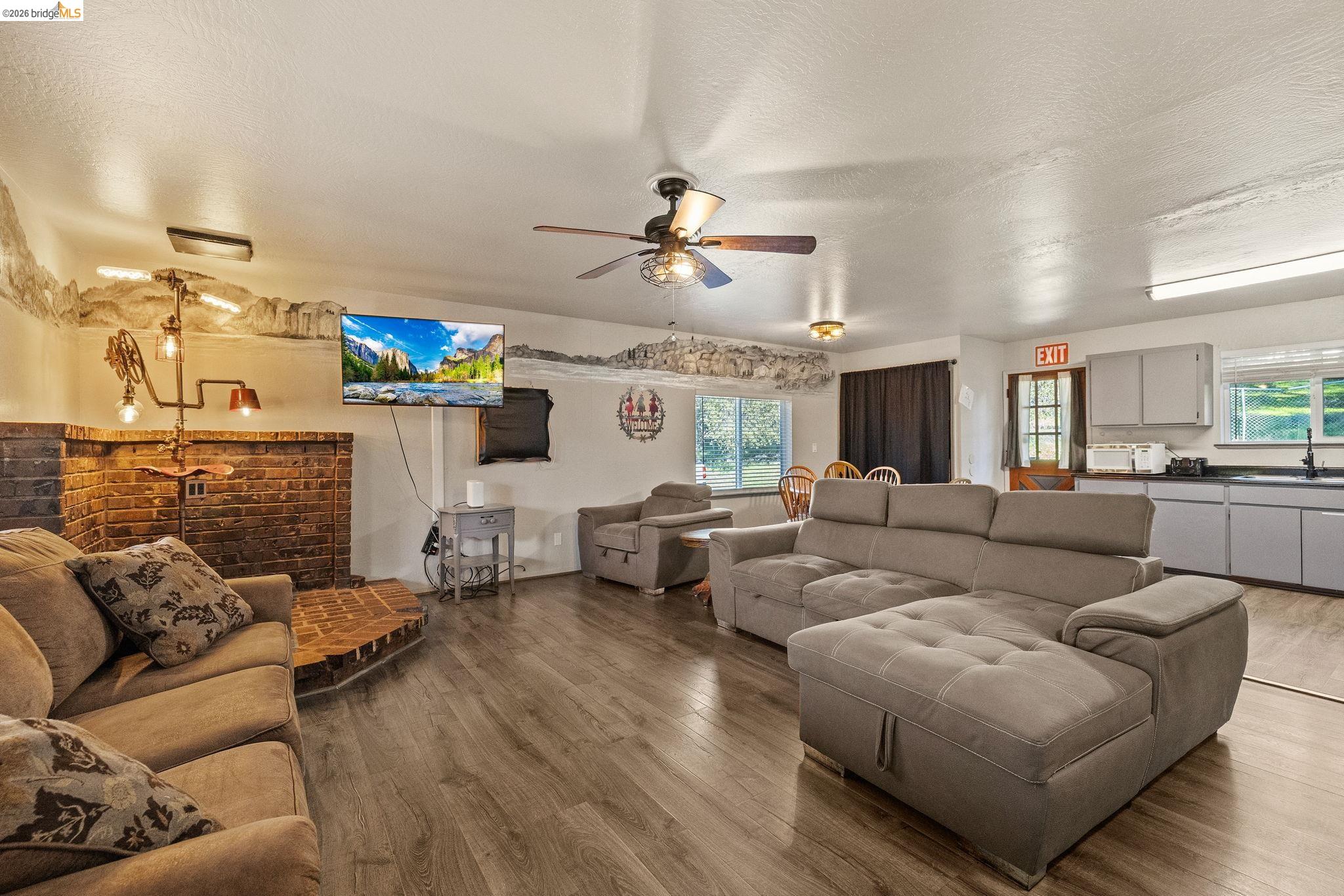 22941 Hudson Road Columbia, CA 95310 - Photo 11 of 34 a living room with fireplace furniture and a chandelier
